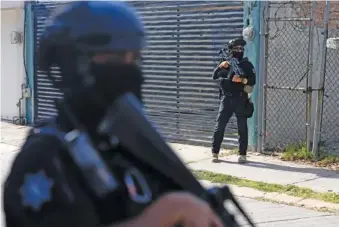  ?? AP PHOTO/FERNANDO LLANO ?? On Feb. 28, municipal police officers patrol a neighborho­od of Celaya, Mexico.