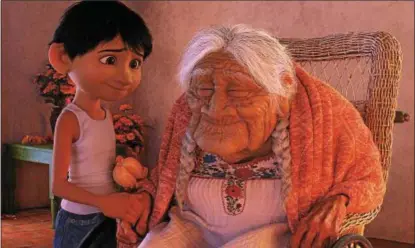  ?? DISNEY-PIXAR ?? Miguel, voiced by Anthony Gonzalez, and Mama Coco, voiced by Ana Ofelia Murguia, are shown in a scene from “Coco.”