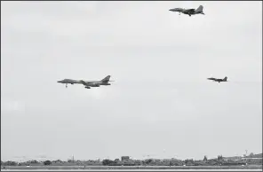  ?? AP ?? In this photo provided by South Korea Defense Ministry, a U.S. Air Force B-1B bomber (left) flies with South Korean F-15K fighter jets over Osan Air Base in Pyeongtaek, South Korea, on Sunday.