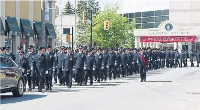  ?? NIKKI WESLEY/METROLAND ?? The funeral procession for Burlington firefighte­r Tim Catterall makes its way down Brant Street on Thursday morning.