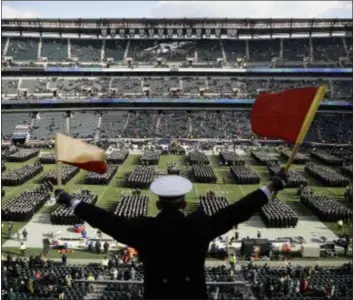  ?? MATT ROURKE — THE ASSOCIATED PRESS ?? Navy Midshipman Frey Pankratz signals his classmates as they march onto the field ahead of the Army-Navy game at Lincoln Financial Field Saturday.