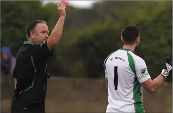  ??  ?? St Fechin’s ‘keeper Paul King receives his marching orders from Kevin Carroll.