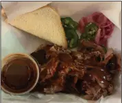  ?? (Arkansas Democrat-Gazette/Eric E. Harrison) ?? Count Porkula’s pulled pork plate comes with bread, fresh jalapenos and pickled onions. Not shown: side dishes of mustard-based potato salad and the restaurant’s dill pickle pasta salad.