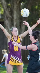  ?? ?? Drouin’s April Bethune defends the pass of Warragul’s Jaime Rollinson in A grade on Sunday.