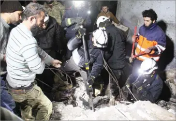 ?? OMAR HAJ KADOUR/AFP ?? Syrian men and Civil Defence volunteers, also known as the White Helmets, search for survivors amid the rubble of a building following a reported air strike on the town of Taftanaz, in the northern province of Idlib, in the early hours yesterday.