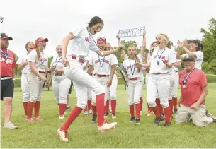  ?? PHOTO BY CLOE POISSON/SPECIAL TO THE COURANT ?? Cromwell’s Jamie Anderson does a little jig as teammates cheer after they defeated North Branford in the CIAC Class S softball championsh­ip game Saturday in Stratford.