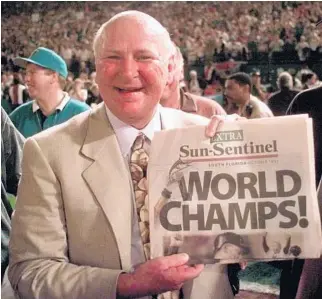  ?? STAFF FILE PHOTO ?? Marlins owner H. Wayne Huizenga holds up a newspaper after the team won the World Series in 1997.