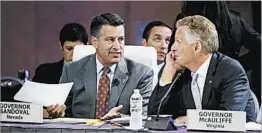  ?? STEPHAN SAVOIA/AP ?? Nevada Gov. Brian Sandoval and Virginia Gov. Terry McAuliffe talk at Saturday’s meeting.