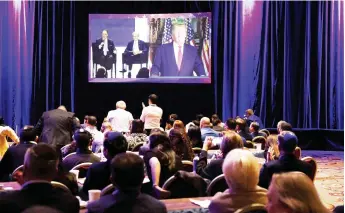  ?? — AFP photo ?? Guests listen to Trump speak via video link at the Republican Jewish Coalition annual leadership meeting in Las Vegas, Nevada.