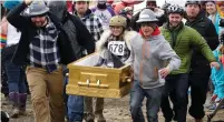  ?? (Rick Wilking/Reuters) ?? A COFFIN RACE team leaves the starting line at the yearly Frozen Dead Guy Days in Nederland, Colorado, on Saturday.