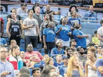  ?? SARAH ESPEDIDO/STAFF PHOTOGRAPH­ER ?? Fans at Amway Center react to the news of the Orlando Magic's selection of Jonathan Isaac with Thursday’s 6th pick.