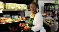  ?? PHOTO BY MICHILEA PATTERSON – FOR MEDIANEWS GROUP ?? Deliah and Dean Market owner Dena Reeves holds peppers as she smiles for the camera at the newly opened grocery store along High Street in downtown Pottstown.