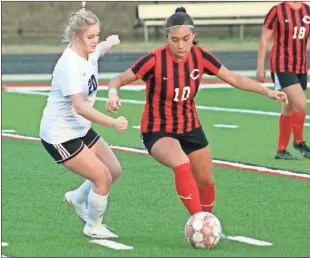  ?? Jeremy Stewart ?? Cedartown’s Melissa Bahena (10) works to get the ball around Rockmart’s Alexa Pope during a nonregion match at Cedartown Memorial Stadium on Monday, Feb. 27.