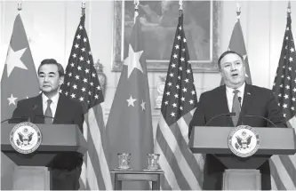  ?? EPA-Yonhap ?? U.S. Secretary of State Mike Pompeo, right, and Chinese Foreign Minister Wang Yi hold a news conference at the beginning of their meeting in the Ben Franklin Room at the State Department in Washington, D.C., Wednesday.