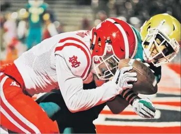  ?? Gina Ferazzi Los Angeles Times ?? AMON-RA ST. BROWN hauls in one of his two touchdown catches against Desmond Talley in the first half.