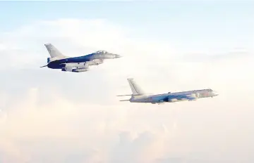  ??  ?? Photo taken and released by Taiwan’s Defence Ministry shows Taiwan’s F-16 fighter (left) jet monitoring one of two Chinese H-6 bombers that flew over the Bashi Channel south of Taiwan and the Miyako Strait, near Japan’s Okinawa Island. — AFP photo
