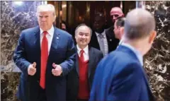  ?? EDUARDO MUNOZ ALVAREZ/AFP ?? President-elect Donald Trump exits an elevator with SoftBank Group Corp CEO Masayoshi Son on December 6.