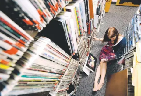  ?? Daily Camera file ?? Megan Chaney alphabetiz­es albums in the music library of Radio 1190 at the University of Colorado in Boulder in 2009.