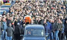  ??  ?? Crowds gathered in Londonderr­y to follow the coffin of Martin McGuinness
