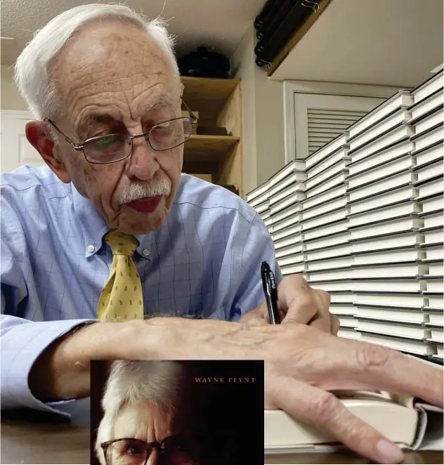  ?? ?? ±
Wayne Flynt signs a copy of his book, ‘Afternoons with Harper Lee,’ at a book-signing function in Homewood, Alabama, on Sept. 22, 2022.