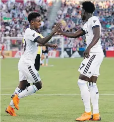  ?? JACK DEMPSEY/THE ASSOCIATED PRESS ?? Whitecaps forward Yordi Reyna, left, celebrates his goal against the Colorado Rapids with teammate Alphonso Davies during the first half Friday in Commerce City, Colo.