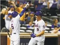  ?? Jim McIsaac / Getty Images ?? The Mets’ Brandon Nimmo (9) celebrates with teammate Jeff McNeil after scoring a run in the eighth inning.