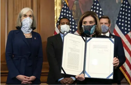  ?? GETTY IMAGES PHOTOS ?? FOR THE SECOND TIME: Speaker of the House Nancy Pelosi displays a signed article of impeachmen­t against President Donald Trump at the U.S. Capitol Wednesday.