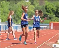  ?? Steven Eckhoff ?? Armuchee’s Shelby Green (left) takes the handoff from Marissa Kimple in the 4x800-meter relay Wednesday at Gordon Central.