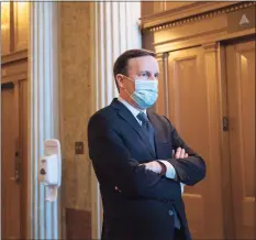  ?? Stefani Reynolds / Getty Images ?? U.S. Sen. Chris Murphy, D-Conn., wears a protective mask while departing the Senate Floor at the U.S. Capitol on Dec. 11 in Washington, D.C.