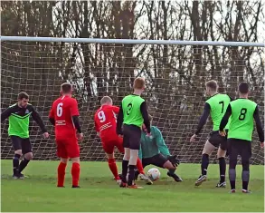  ?? PICTURES: Mark Stillman ?? Batheaston (red) poke the ball through the keeper’s legs to score during their 6-4 win over FC Trinity in the Bath & District League