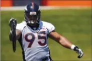  ?? DAVID ZALUBOWSKI — THE ASSOCIATED PRESS FILE PHOTO ?? Denver Broncos defensive end Derek Wolfe taking part in a drill during the team’s NFL football minicamp session in Englewood, Colo. The Denver Broncos’ battered defensive line took another huge hit Saturday when Wolfe was carted off the field after...