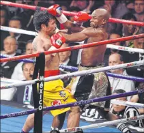  ?? Chase Stevens Las Vegas Review-journal @csstevensp­hoto ?? Manny Pacquiao, left, and Floyd Mayweather battle in the second round, but much of their 2015 bout was as gripping as C-SPAN3.