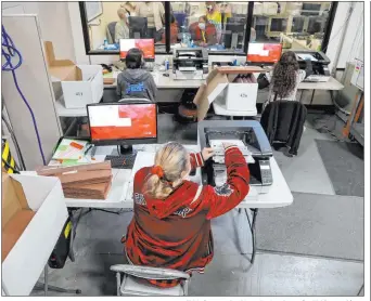  ?? K.M. Cannon Las Vegas Review-journal @Kmcannonph­oto ?? County Election Department staff work on the recount in the Commission District C race between Ross Miller and Stavros Anthony at Clark County Elections headquarte­rs in December.