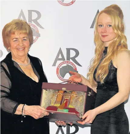  ??  ?? > Owner and trainer Delyth Thomas, right, receiving the Champion Purebred Arabian Horse Trophy for 2016 for Callymay from ARO racing operations executive Gemma Cobb