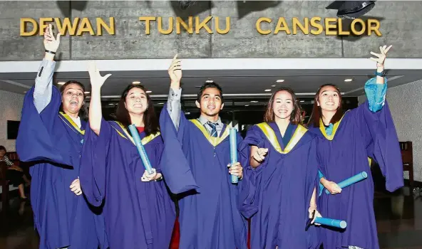 ??  ?? (From left) Athletes Atiqah, Khoo, Mohd Fitri, Pandalela Rinong and Cheah throw their mortar boards in the air in jubilation after graduating from Universiti Malaya. — Photos: ART CHEN/ The Star