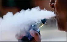  ?? AP FILE ?? A man exhales while smoking an e-cigarette in Portland, Maine.