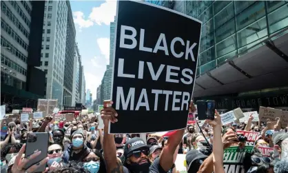  ?? Photograph: Ira L Black - Corbis/ Corbis/Getty Images ?? A man holds up a ‘Black Lives Matter’ sign during a demonstrat­ion in New York City on 7 June 2020.