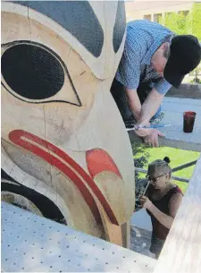  ?? COURTESY OF CANTOR ARTS CENTRE AT STANFORD UNIVERSITY ?? John Livingston is shown restoring totems at Stanford University in Palo Alto, California, with his wife Maxine Matilpi.