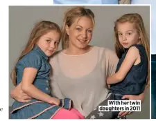  ??  ?? With her twin daughters in 2011