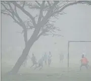  ?? PARVEEN KUMAR/ HT PHOTO ?? Boys play football amid foggy weather at Sector 29 in Gurugram. The city recorded an AQI of 300 on Sunday.