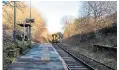  ??  ?? All aboard: passengers wanting to take the train have to flag it down as it arrives