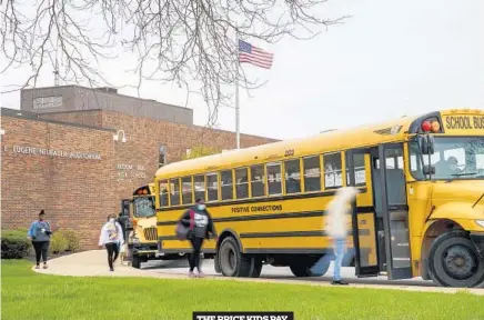  ?? THE PRICE KIDS PAY ARMANDO L. SANCHEZ/CHICAGO TRIBUNE ?? Above, Students walk outside Bloom Trail High School last month in Steger. Black students received nearly all of the tickets issued recently at the school.