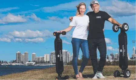  ?? Main picture: REGI VARGHESE ?? Premier of Queensland Exporter of the Year winners Fleur and Jeff Anning of Evolve Skateboard­s with their Evolve GT Series boards; Grace Loves Lace designer Megan Ziems (below left) and Opmantek’s Danny Maher.