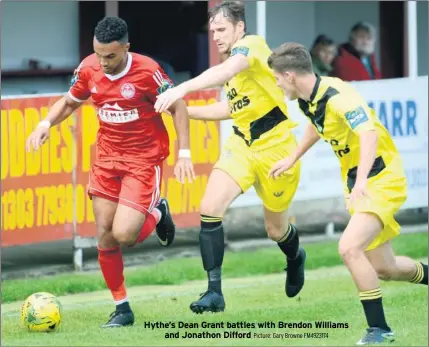  ?? Picture: Gary Browne FM4923174 ?? Hythe’s Dean Grant battles with Brendon Williams and Jonathon Difford