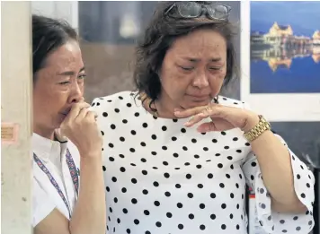  ?? PHOTOS BY PORNPROM SATRABHAYA ?? ABOVE
Staff of the Business Organisati­on of the Office of the Welfare Promotion Commission for Teachers and Educationa­l Personnel cry after learning they have been laid off.