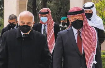  ?? Jordanian Royal Palace / AFP / Getty Images ?? Prince Hassan Bin Talal (left), Prince Hamzah (center) and King Abdullah II (right) arrive at Raghadan Palace to pay their respects at the graves their forefather­s in the capital of Amman.