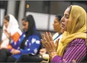  ?? Francine Orr Los Angeles Times ?? ZEENAT PARVEZ prays at Artesia City Church, where many members of the congregati­on have had family in India fall ill or die from COVID-19.