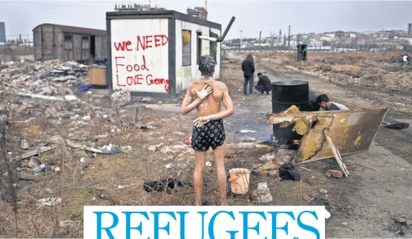  ?? MUHAMMED MUHEISEN, AP ?? A 14- year- old unaccompan­ied minor from Afghanista­n showers near an old train car in February in Belgrade, Serbia, where he and other migrants took refuge. Many refugees want to move to Germany, Britain or other more prosperous countries.