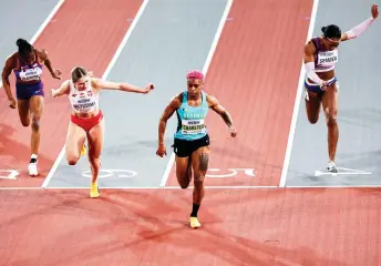  ?? — AFP photo ?? (From left) USA’s Christina Clemons, Poland’s Pia Skrzyszows­ka, Bahamas’ Devynne Charlton and Britain’s Cindy Sember cross the finish in the Women’s 60m hurdles semi-final 1 during the Indoor World Athletics Championsh­ips in Glasgow, Scotland.