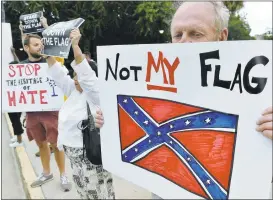  ?? MLADEN ANTONOV/AGENCE FRANCE-PRESSE VIA GETTY IMAGES ?? A man holds up a sign Saturday at a protest against the Confederat­e flag in Columbia, South Carolina. Seemore photos at http://photos.mercurynew­s.com.